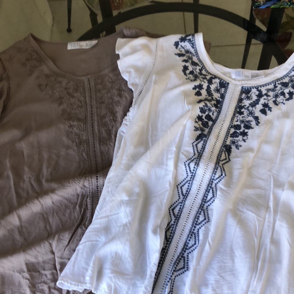 White blouse with blue stitching and brown blouse